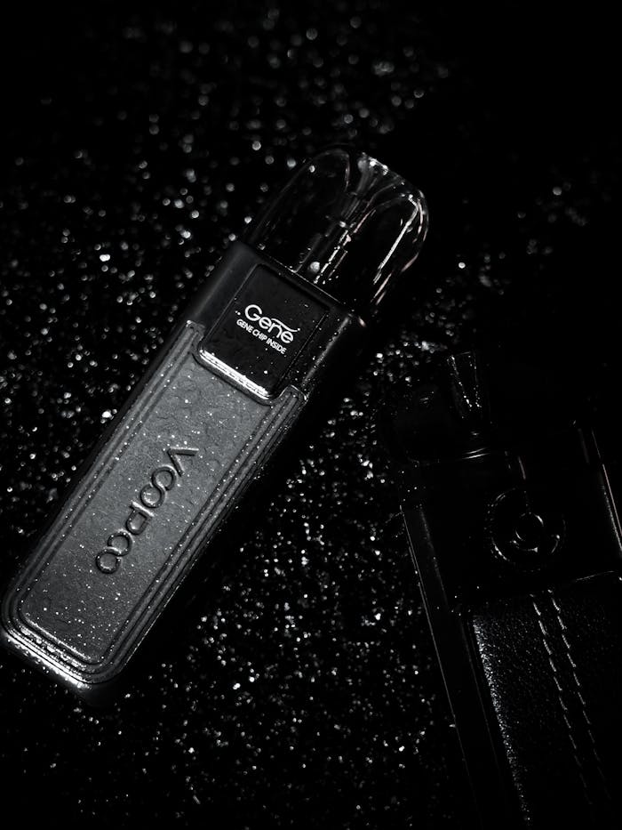 pexels photo 23319707 Artistic black and white photo of a vape in a leather case with water droplets.